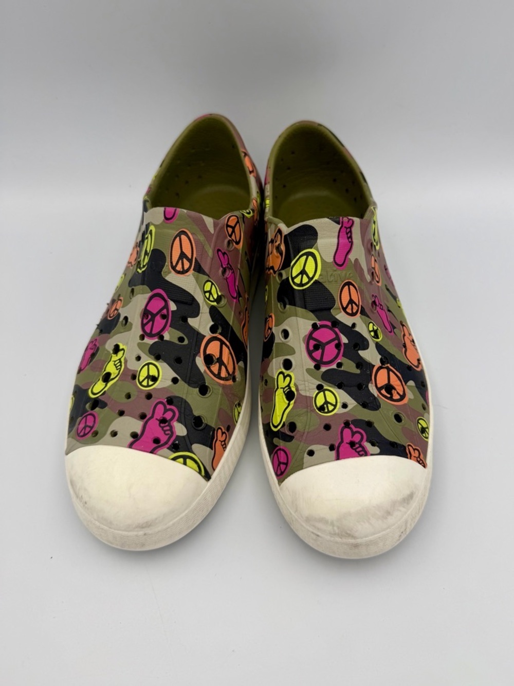 Native Kids Slip-On Sneakers in Neon Pink, Orange, Yellow & Black Peace Print